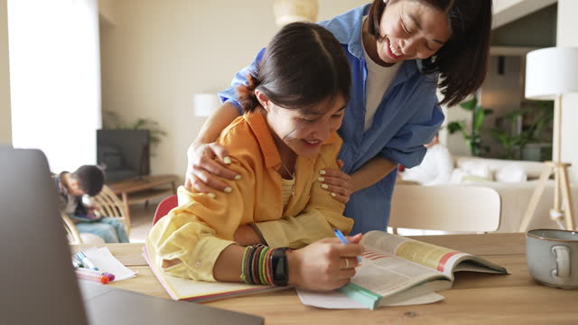 Mother helping her daughter with the studying