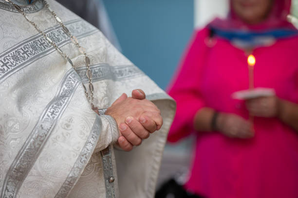 istock Folded hands of an Orthodox priest in a cassock. 1569753177