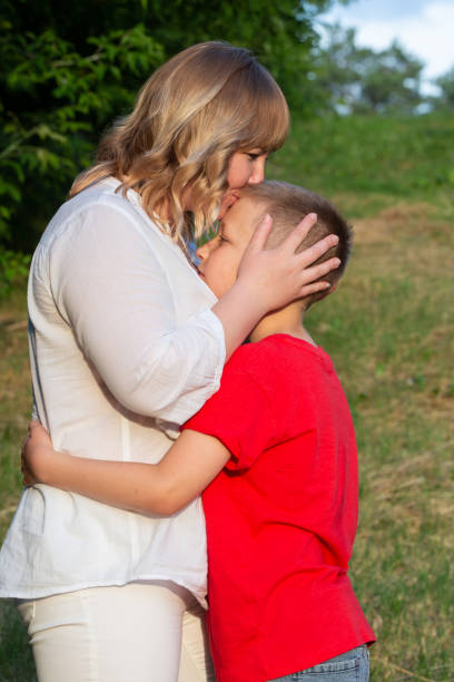 istock Happy mom and son hugging on a summer walk. 1569753194