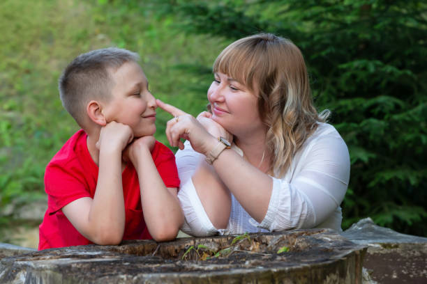 istock Happy mom and son on a summer walk play and chat. 1569753745
