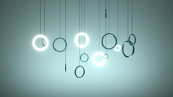 This 3D rendering features rings hanging in space. The rings are rendered in a realistic style, and they appear to float and rotate in a mesmerizing and calming way.