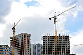 construction site with apartment buildings and cranes isolated copy space