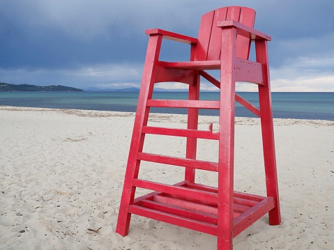 Red lifeguard chair on the beach