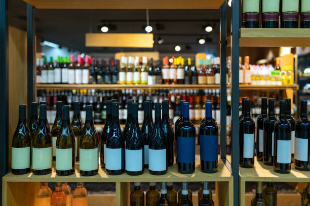 istock Bottles of wine in a row on shelf. 1569771222
