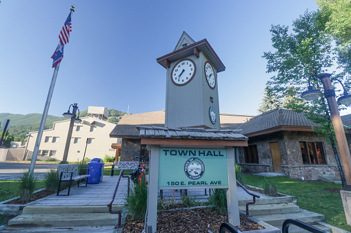 A clock tower at Jackson Town Hall on East Pearl Avenue in Jackson Hole of Teton County, Wyoming, and a visible logo.