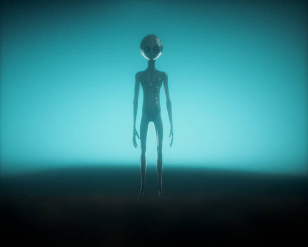 istock Alien on dark foggy background. Unknown and ufo concept. 1569778209