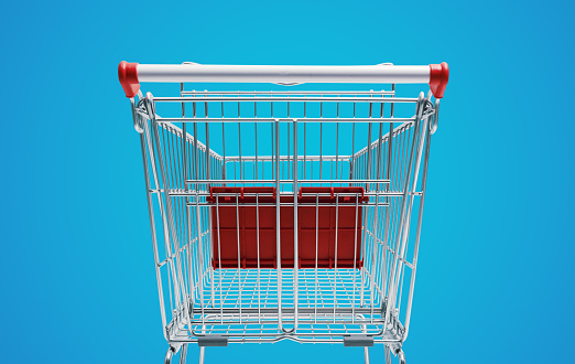 Empty supermarket shopping cart: grocery shopping and retail concept