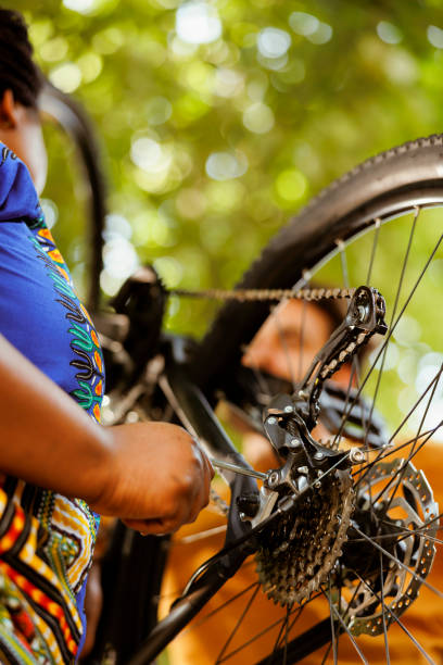 istock Young woman securing bicycle chain 1569785469
