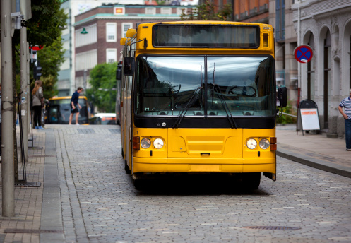 Yellow bus on europe city street.
