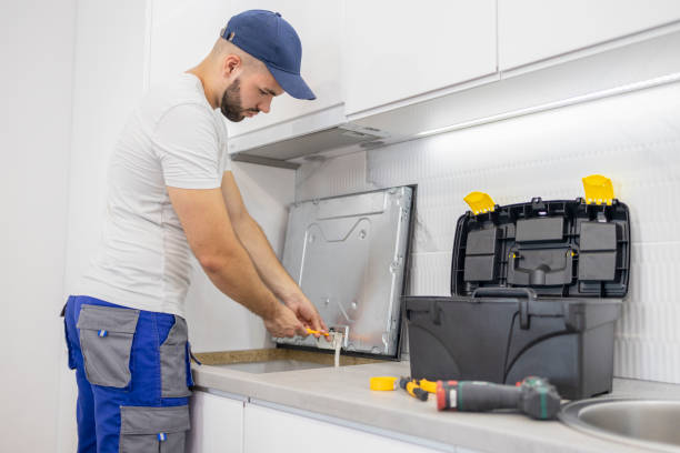 istock Man connecting kitchen appliances with electricity 1569799057