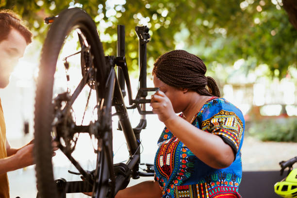 istock Multiracial couple repairing bicycle 1569801266