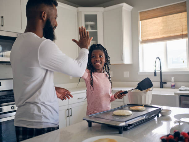 istock Father and Daughter Cooking and Eating a Pancake Breakfast 1569803935
