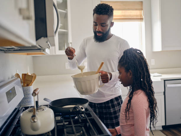 istock Father and Daughter Cooking and Eating a Pancake Breakfast 1569805546