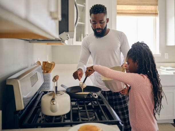 istock Father and Daughter Cooking and Eating a Pancake Breakfast 1569806093
