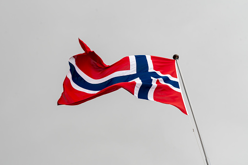 Flag of Norway flying on flagpole