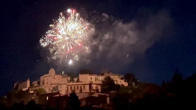 Fireworks and a crescent moon over Simiane la Rotonde