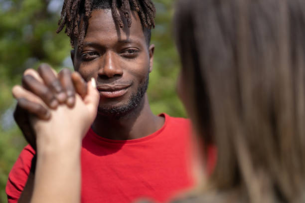 istock Interracial Couple Holding Hands 1569809917