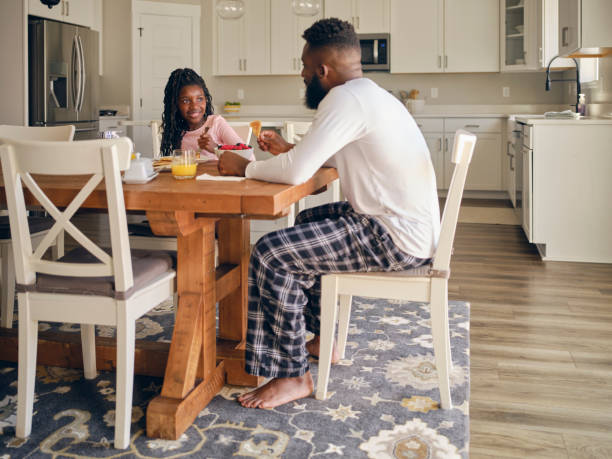istock Father and Daughter Cooking and Eating a Pancake Breakfast 1569812651