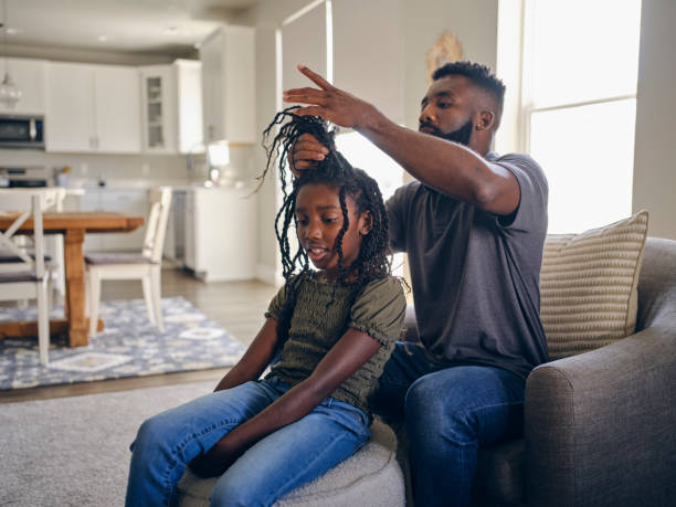 istock Father Helping Daughter with Her Hair 1569818672