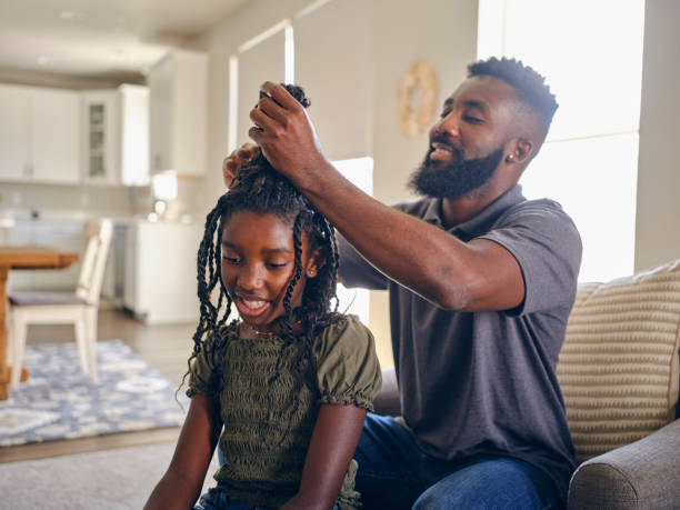 istock Father Helping Daughter with Her Hair 1569819198