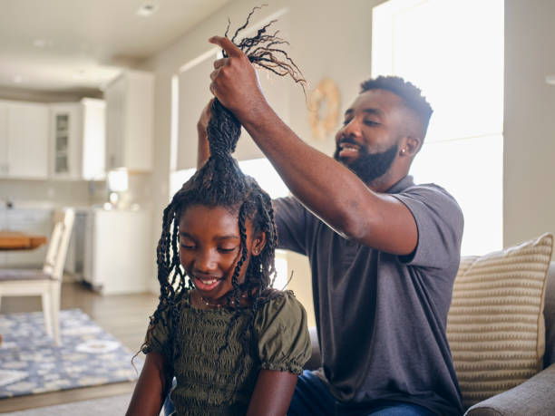 istock Father Helping Daughter with Her Hair 1569819727