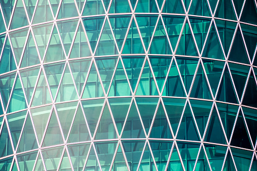 Glass facade of a modern energy-saving house with triangular window frames