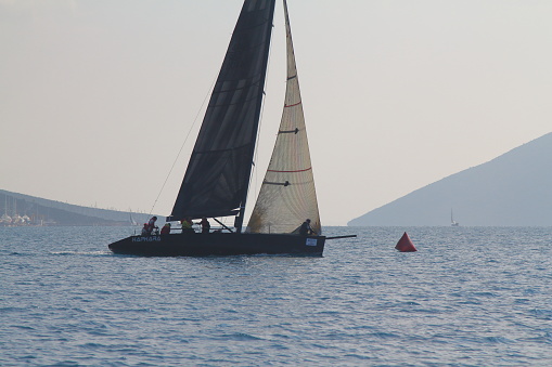 Istanbul, Turkey - June 14, 2020: Sailing yatchs travel at coast of bosphorus of marmara sea near kadıköy istanbul in a summer day.