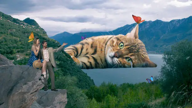 Contemporary art collage. Lovely couple looking on beautiful nature view with mountain and lake. Gian cat lying in water. Concept of animal theme, surrealism, fantasy and imagination. Creative design
