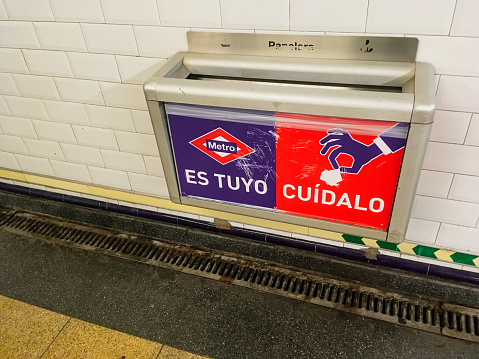 Madrid Spain. 08 22 2019. Trash can with the metro logo hanging on the wall.