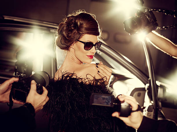 Glamorous Celebrity Woman Surrounded By Paparazzi Photographers Glamorous celebrity woman surrounded by paparazzi photographers on a red carpet in front of her car. celebrities photos stock pictures, royalty-free photos & images