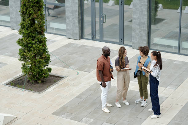istock group of young multicultural employees in casualwear discussing working points 1569851002