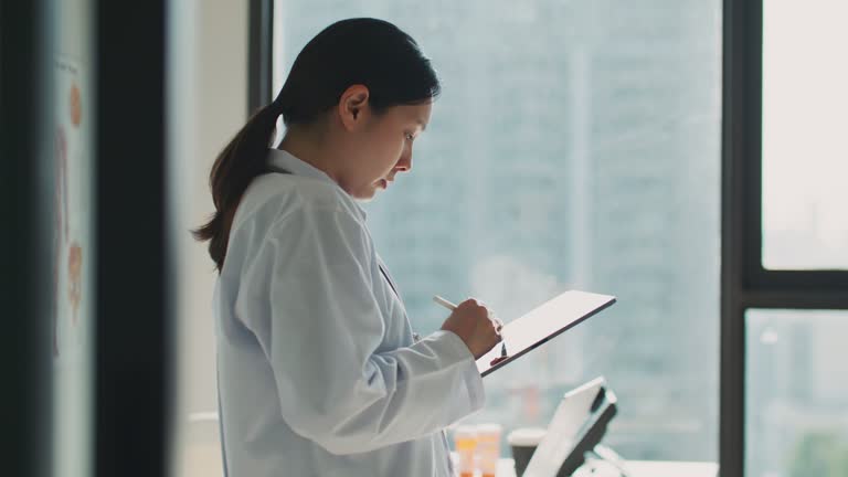 Close-up of Hand doctor holding and using a digital tablet working at a modern hospital