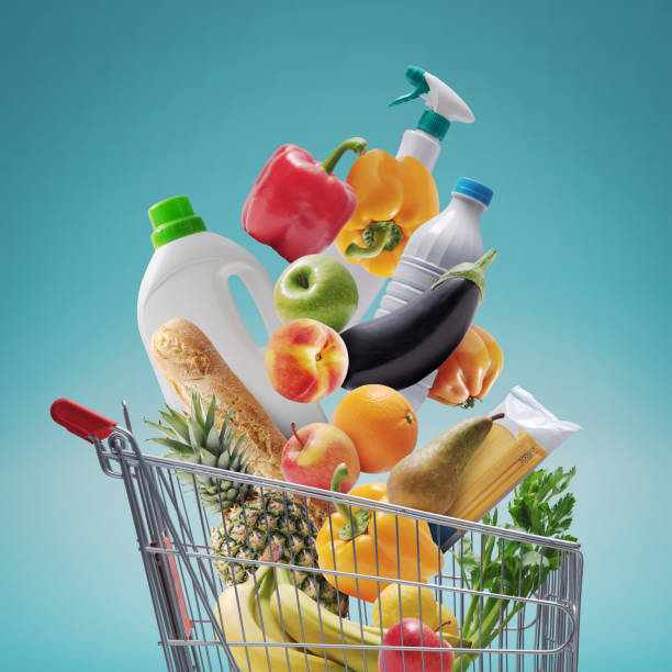 istock Groceries and goods falling in a shopping cart 1569853384