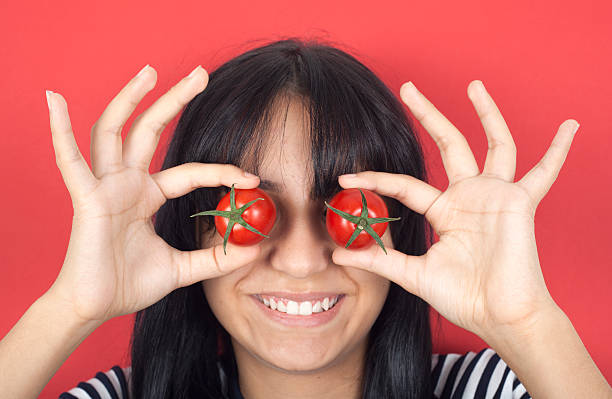 istock Woman holding tomato over eyes 156985733