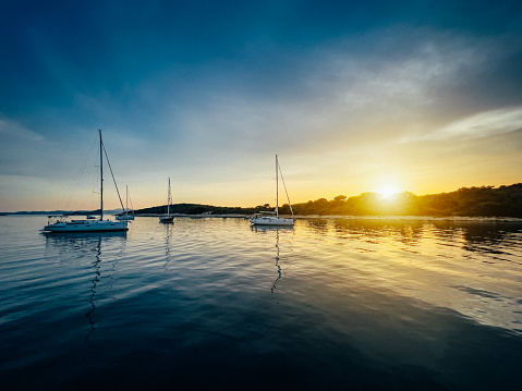 Anchored sailboats at island Solta, Dalmatia, Croatia at sunset.