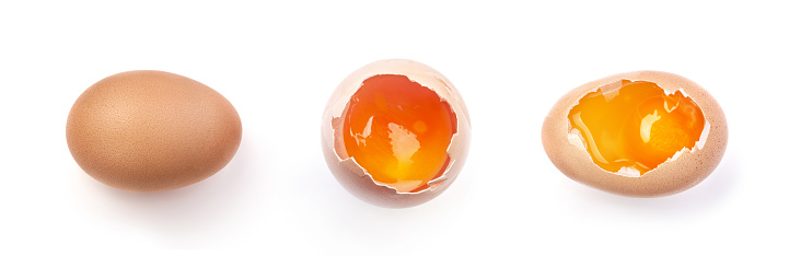 Egg yolk in the shell isolated on white background