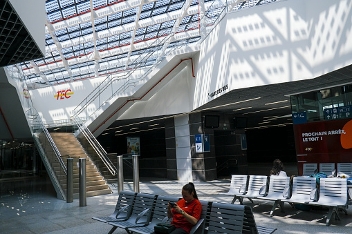 A woman sits in bus stop  in the city center of Namur in Belgium on July 22, 2023.