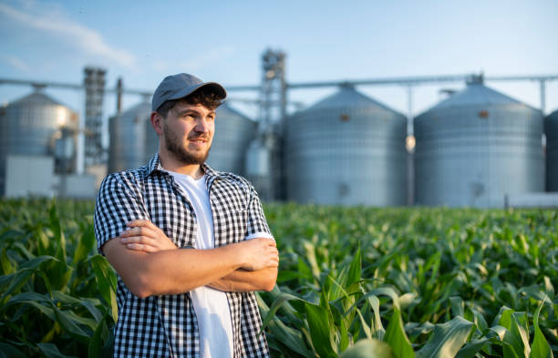 istock Portrait of confident farmer standing in the corn fields. 1569903579