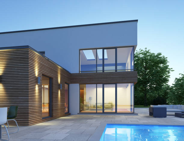 istock Modern cubic house with pool in the evening 1569911782