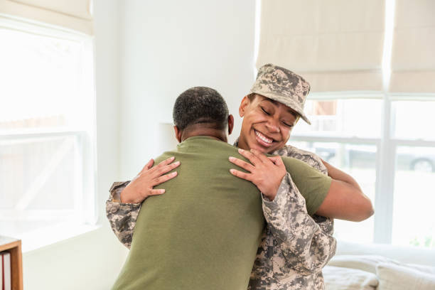istock Father embraces his daughter who arrived home after being gone for a year on deployment 1569917753