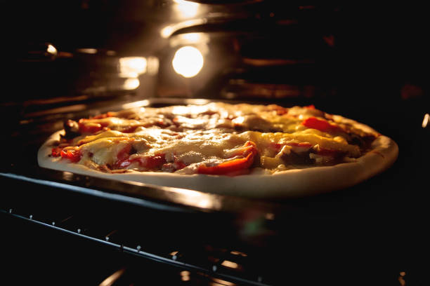 istock Baking homemade pizza in the oven 1569920485