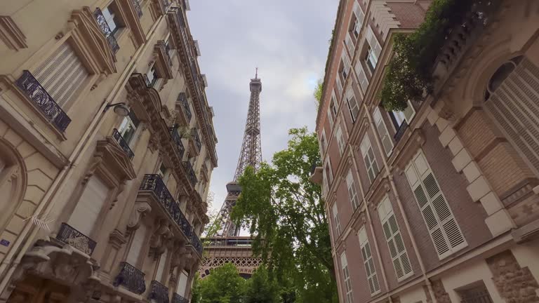 Parisian street view of the Eiffel Tower. Parisian architecture in the center of the cityscape