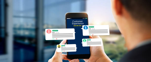 istock customer feedback,experience,review concept.Hands holding mobile phone 1569940306