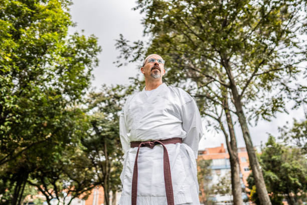 istock Mature man contemplating while look away at public park 1569956209