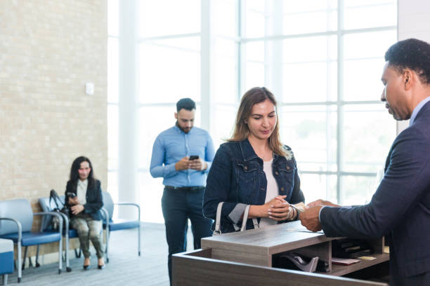 istock Woman listens as banker explains loan application paperwork 1569975872
