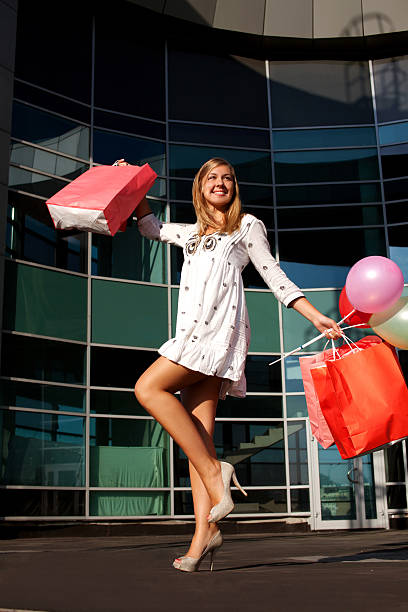 Happy woman shopping and holding bags stock photo