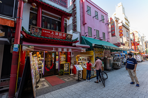 Kobe, Japan - August 18, 2022 : People at the Kobe Chinatown in Hyogo Prefecture, Japan. Many Chinese restaurants are located in Chinatown, it is a popular tourist attraction and dining district.