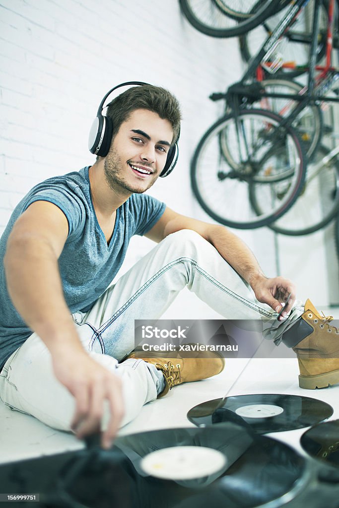 Playing music at home Young man playing music in the garage. 20-24 Years Stock Photo