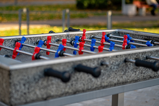 outdoor football table to play football with red and blue players, close-up