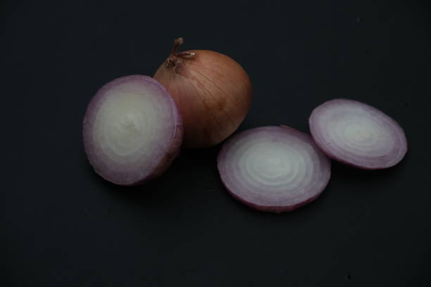 istock Onions slices on black background , normal angle of view 1570008007